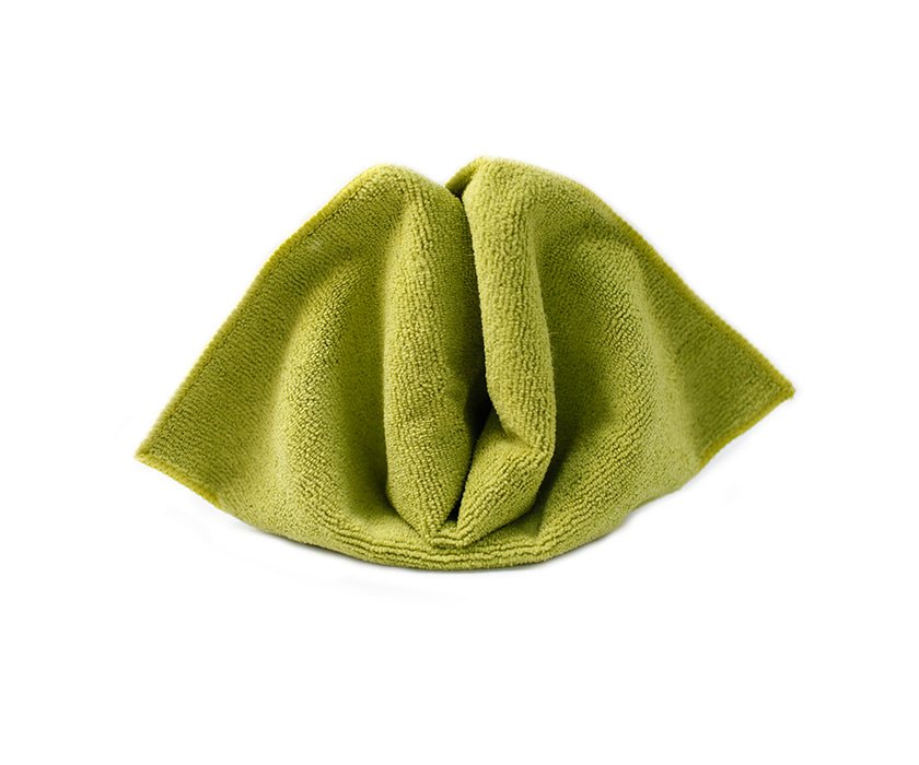 Microfiber cleaning cloth in vibrant green, neatly folded and ready for use. Ideal for dusting, wiping, and polishing surfaces to a streak-free shine.